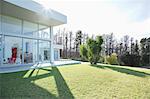 Modern house casting shadows on manicured lawn