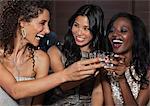 Women toasting each other at party