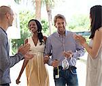 Friends cheering smiling couple