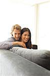 Smiling couple relaxing on sofa