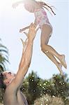 Father and daughter playing in swimming pool