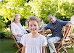 Girl smiling in backyard with grandparents