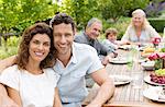 Couple smiling at table outdoors