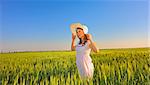 beautiful girl with hat in wheat field