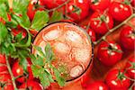 Blood mary alcohol cocktail (top view) with cherry tomatos and celery on background