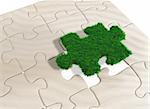 a last missing puzzle piece made of grass is going to be inserted in a puzzle made of sand