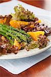 Asparagus salad with oranges, lollo rosso lettuce and hemp seeds