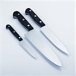 Three kitchen knives. Blue toned