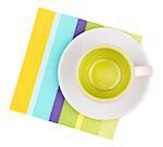Empty cup on color placemat. Isolated on white background