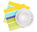 Empty white cup on color placemat. Isolated on white background