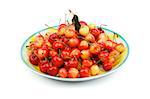 Delicious Yellow and Red Sweet Cherries on Big Plate isolated on white background