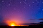 Kilauea Volcano glows under a starry night sky at Hawaii Volcanoes National Park on the Big Island of Hawaii.