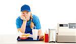 Teenage worker in a fast food restaurant bored and leaning on the counter.  White background.