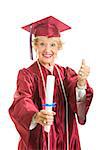 Happy senior lady graduates in her cap and gown, giving thumbs up.