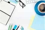 Blue coffee cup and office supplies. View from above. Closeup on white background