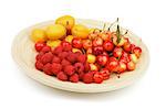 Arrangement of Juicy Apricots, Sweet Cherries and Raspberries on Wooden Plate isolated on white background