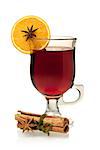 Hot mulled wine with orange slice, anise and cinnamon sticks. Isolated on white