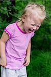 little girl crying heavily on green background