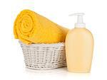 Shampoo bottle and yellow towel. Isolated on white background