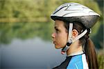 portrait of young woman training on mountain bike and contemplating landscape. Copy space