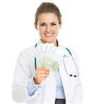 Smiling doctor woman showing fan of euros