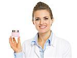 Smiling cosmetologist woman showing cream bottle