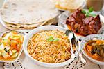 Indian meal biryani rice, chicken curry, masala milk tea, acar vegetable, roti chapatti and papadom.