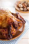 Roast chicken ready to eat on dining table.