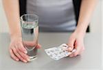 Closeup on pills in hand of young woman