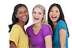 Diverse laughing women looking at camera on white background