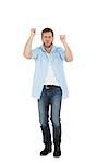 Cheerful casual man cheering on white background