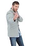 Trendy model posing wearing a blazer on white background