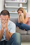 Young Couple having difficulties in sitting room at home