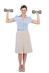 Strong businesswoman posing with dumbbells against white background