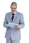 Happy businessman using tablet pc against white background