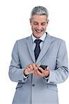 Happy businessman sending text message against white background