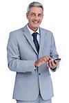 Cheerful businessman sending text message looking at camera against white background and looking at camera