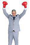 Businessman posing on white background with red boxing gloves hands up