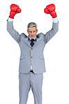 Furious businessman posing with red boxing gloves on white background