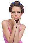 Retro styled model in hair curlers posing on white background