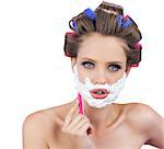 Delightful model in hair curlers posing with razor on white background