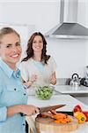 Relaxed women cooking together in the kitchen