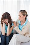 Upset woman with her therapist in office at a session