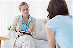 Young psychologist listening to her patient in private session