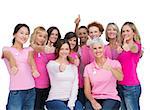 Voluntary women posing on white background and wearing pink for breast cancer