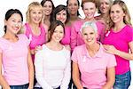Voluntary pretty women posing and wearing pink for breast cancer on white background