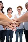 Relaxed models joining hands in a circle on white background