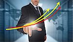 Businessman touching red and yellow growth lines with world map on background in data center
