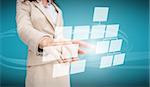 Businesswoman touching futuristic flow chart interface on blue background