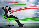 Confident businessman reclining in swivel chair with red and green arrows in cloudy landscape